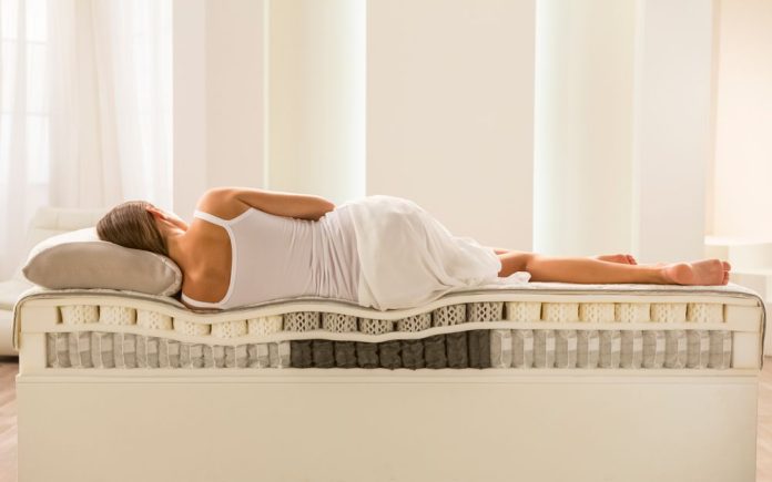 woman lying on octapring mattress cutaway